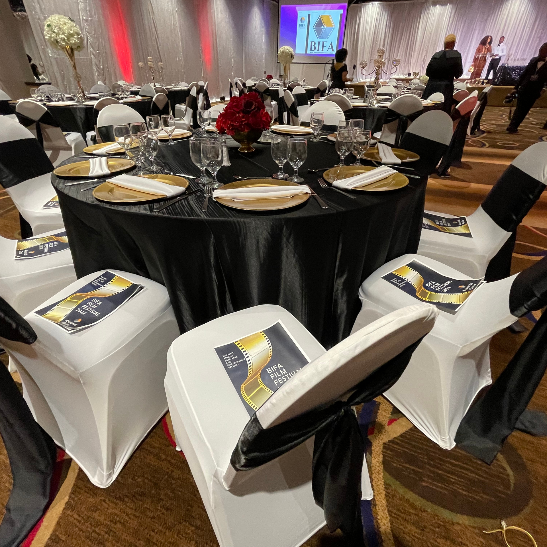 A large room with tables and chairs set up for a party