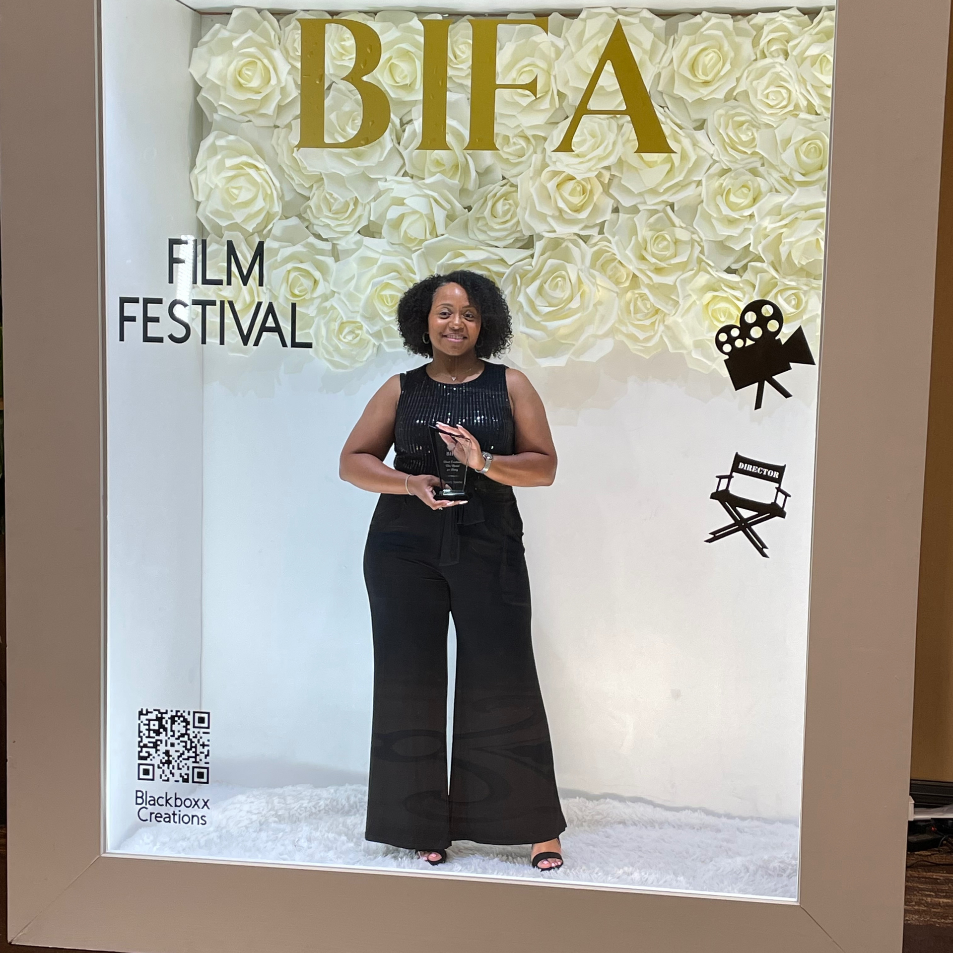 A woman is standing in front of a wall that says bifa film festival