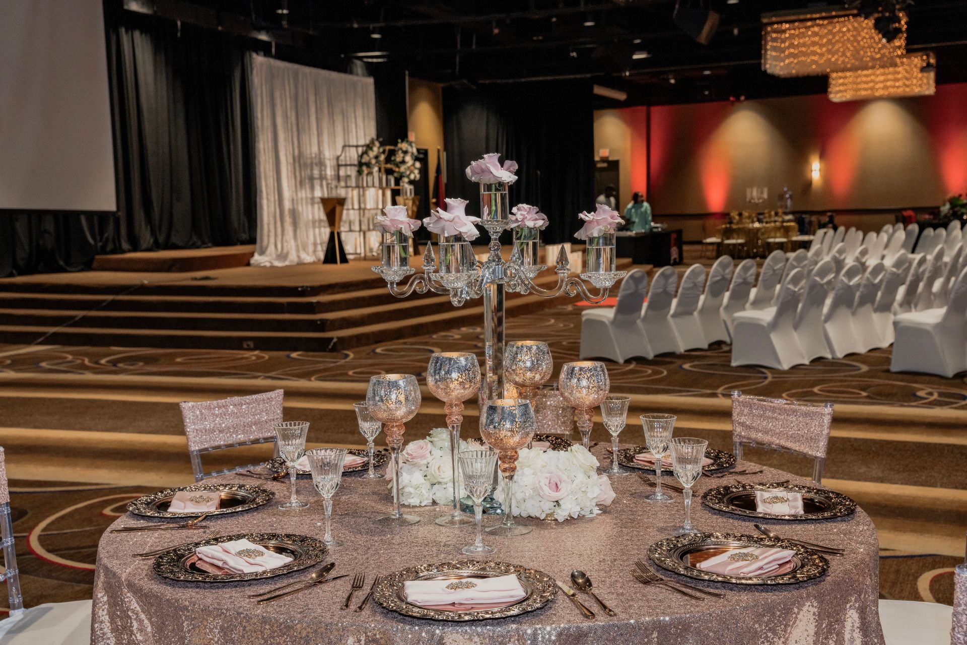 A table set for a wedding reception in a large room.