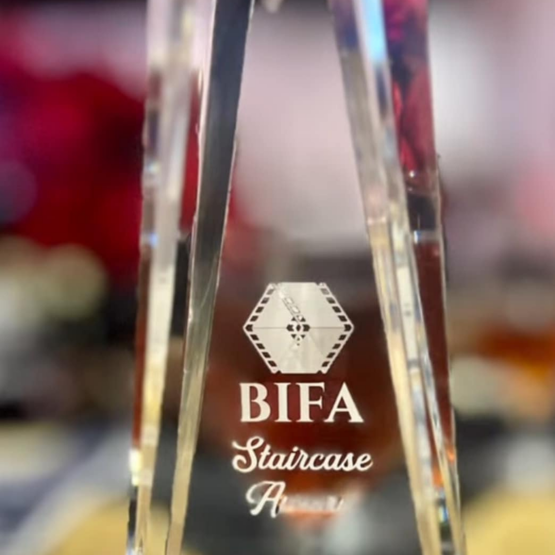 A clear trophy that says ' bifa staircase award ' on it