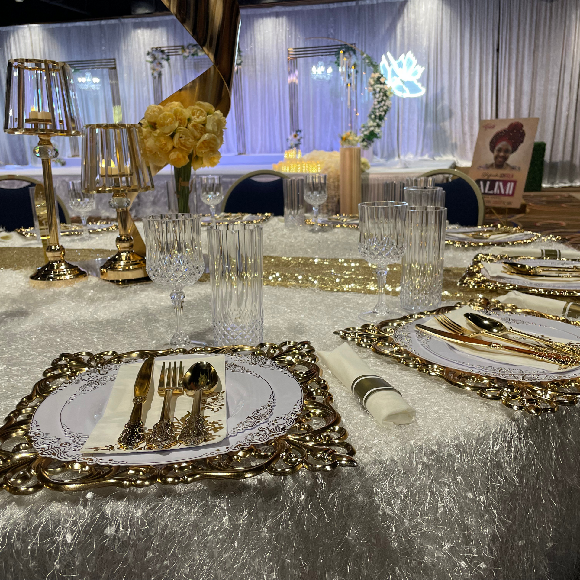 A table set for a wedding reception with plates and silverware