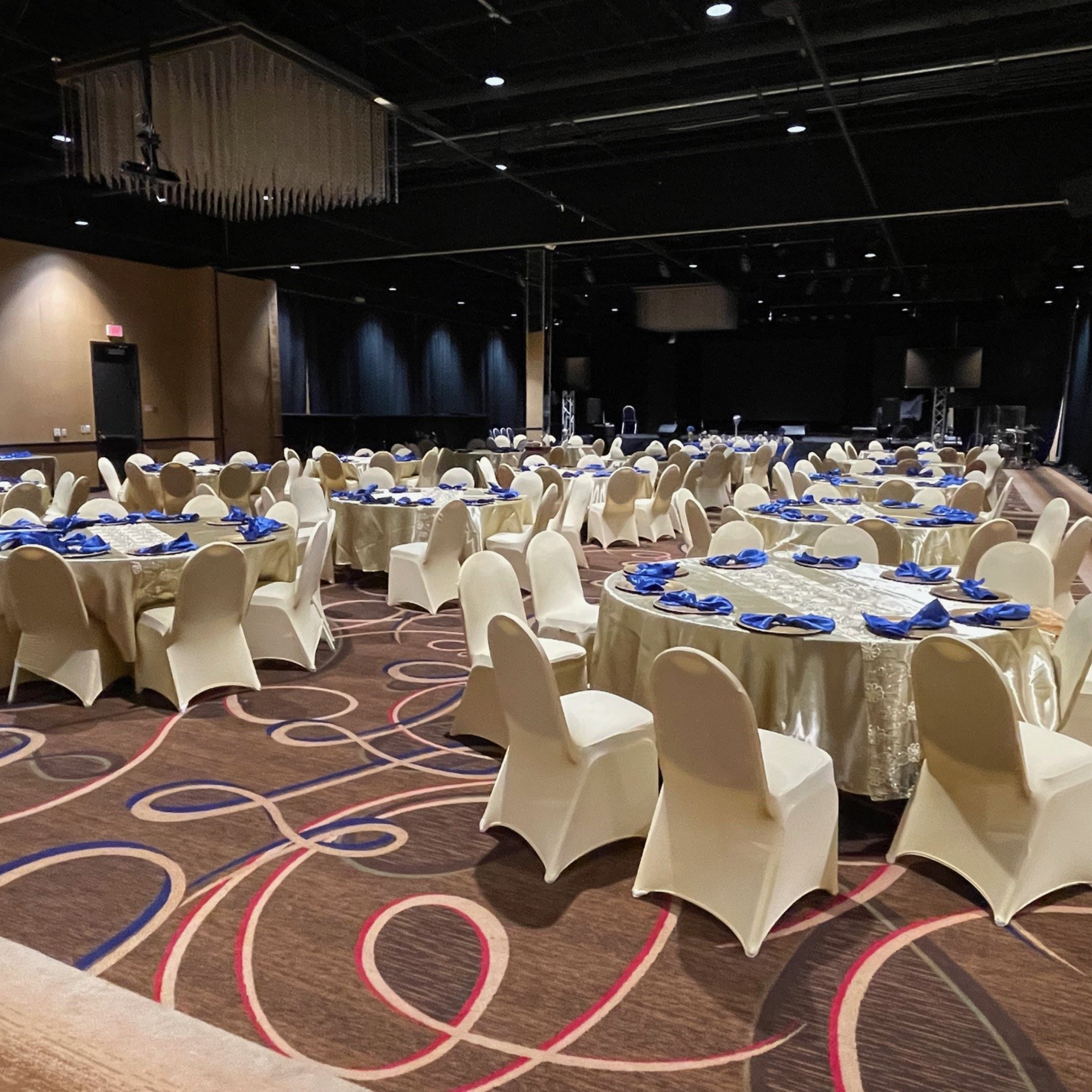 A large room with tables and chairs set up for a party