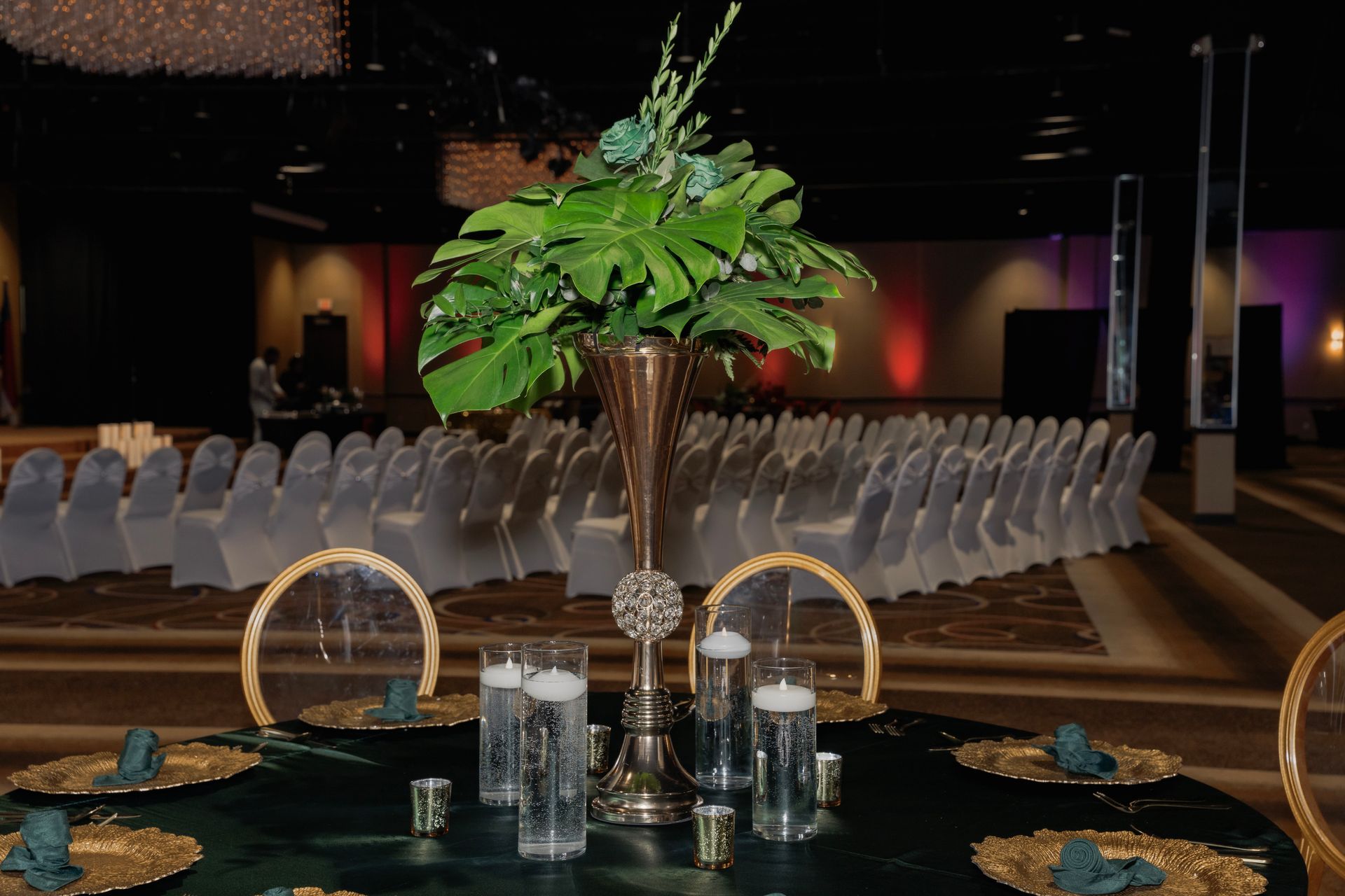 A table with a vase of flowers and candles on it.