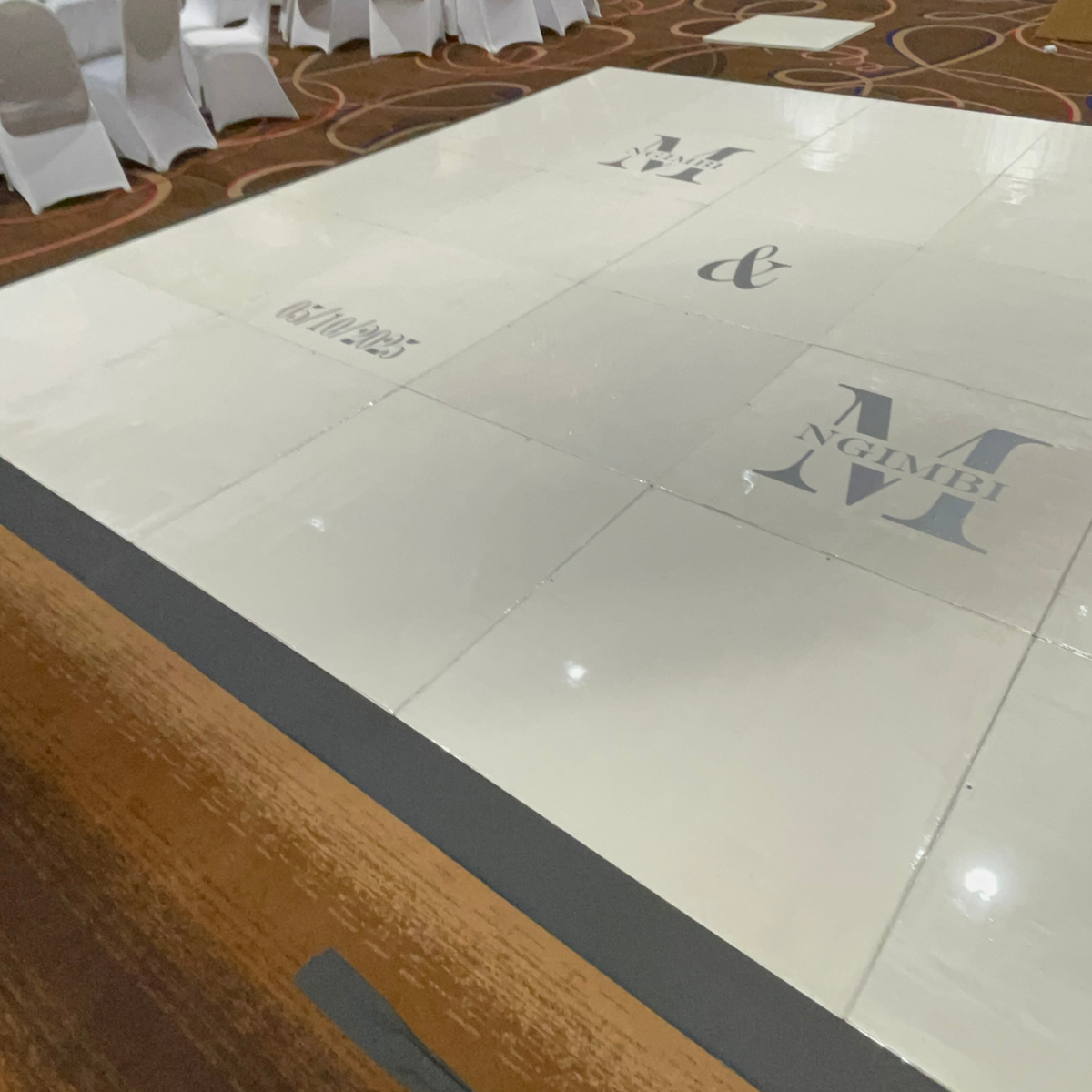 A white dance floor with a monogram on it