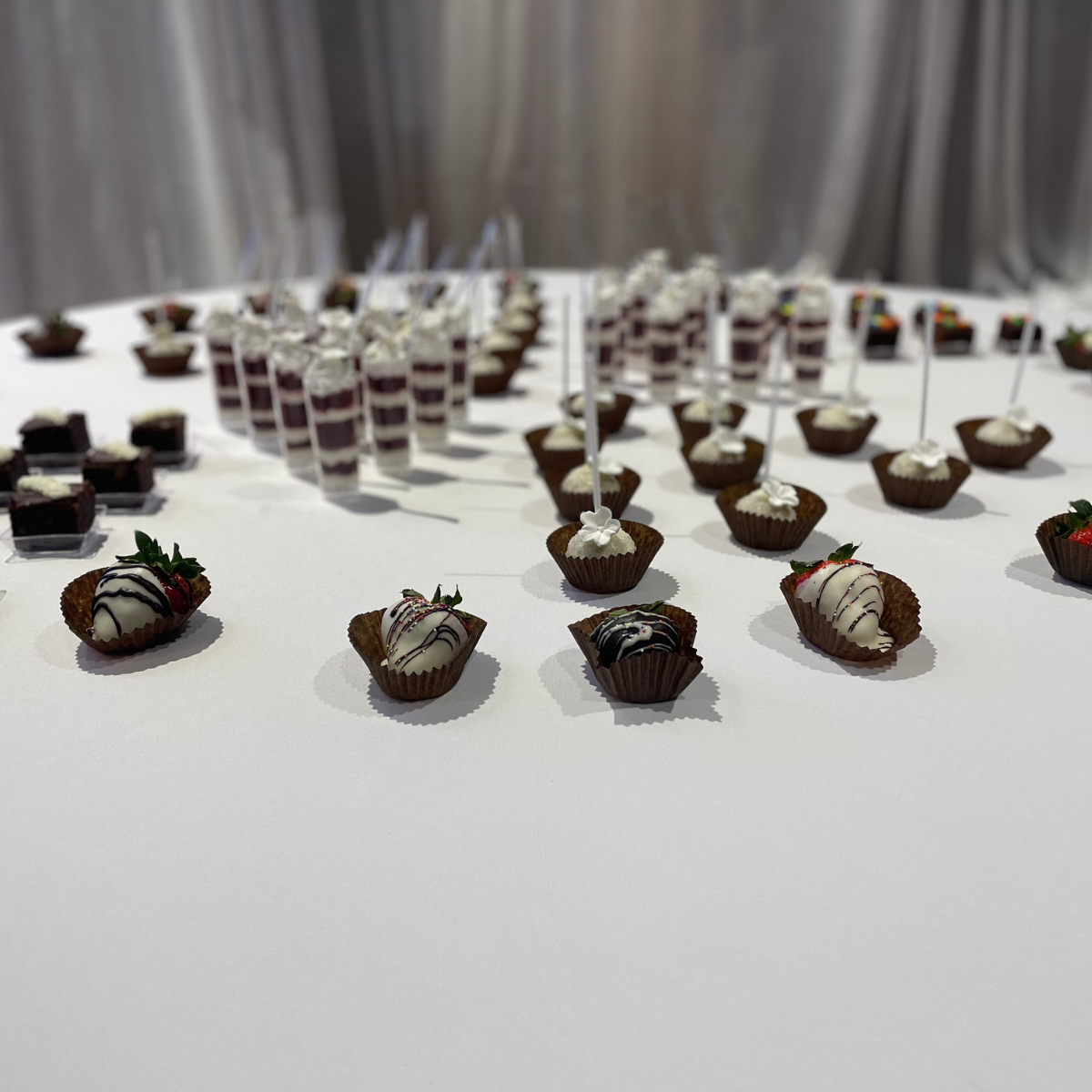 There are many different types of desserts on the table.