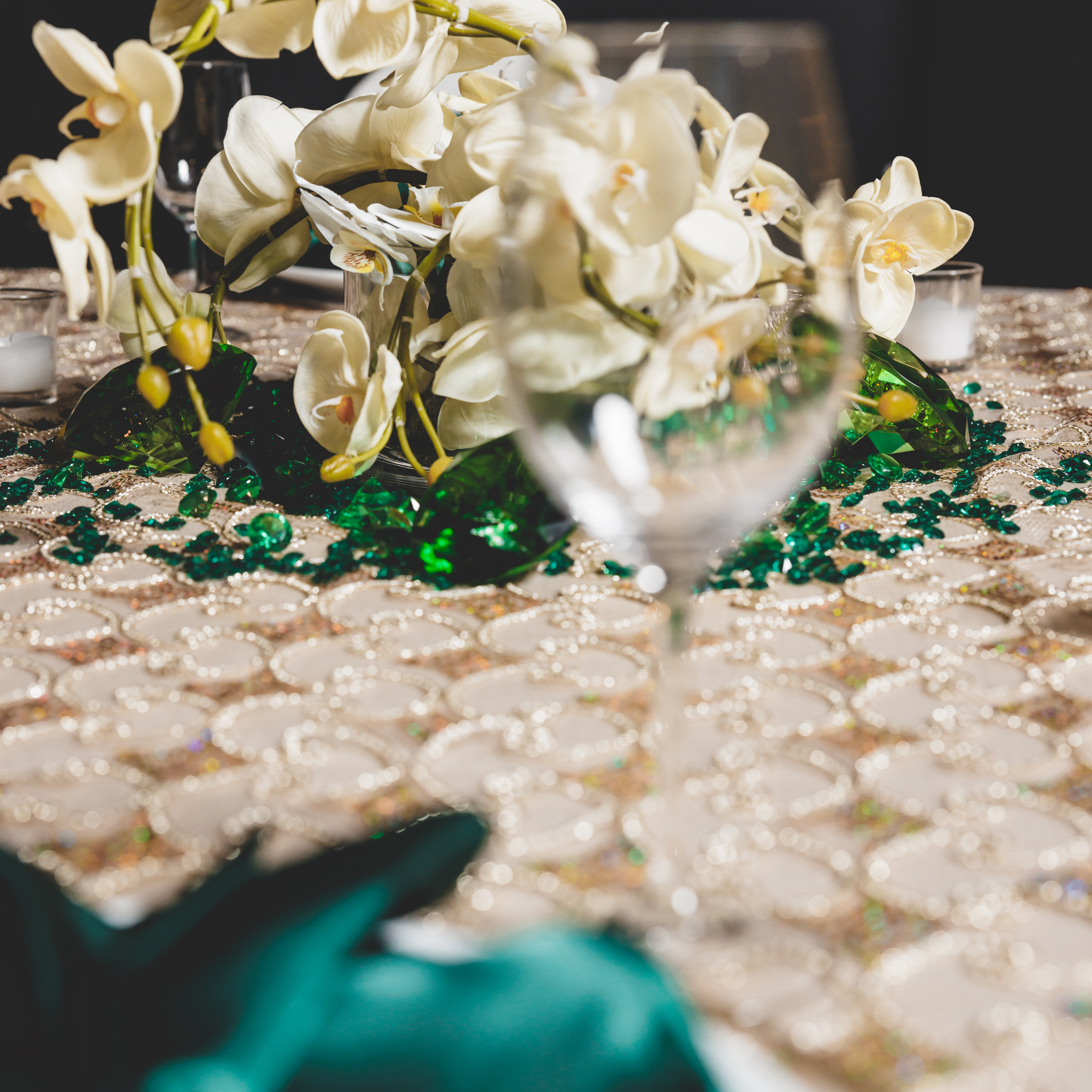 A table with flowers and a wine glass on it