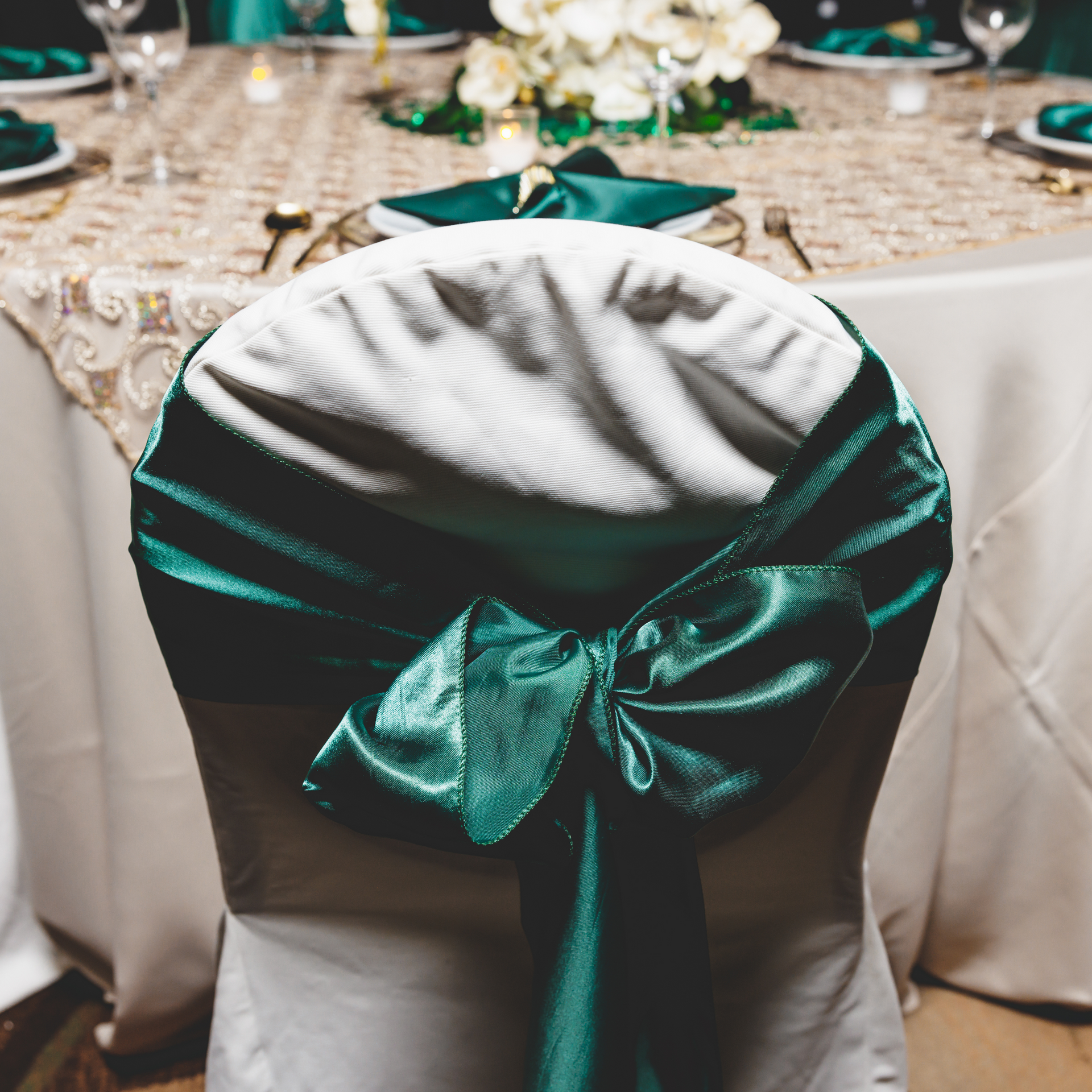 A white chair with a green bow on it