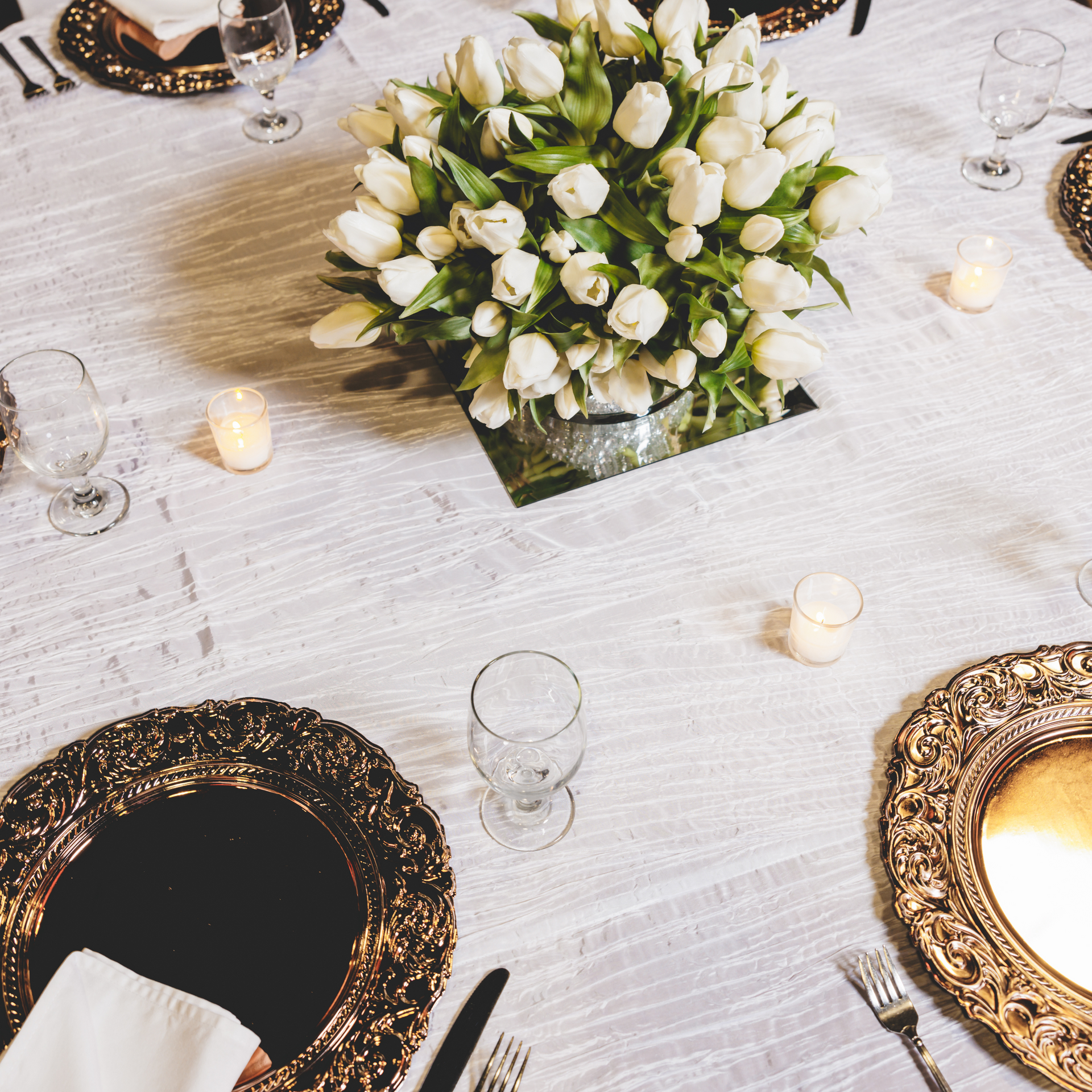 A table with a vase of white flowers on it