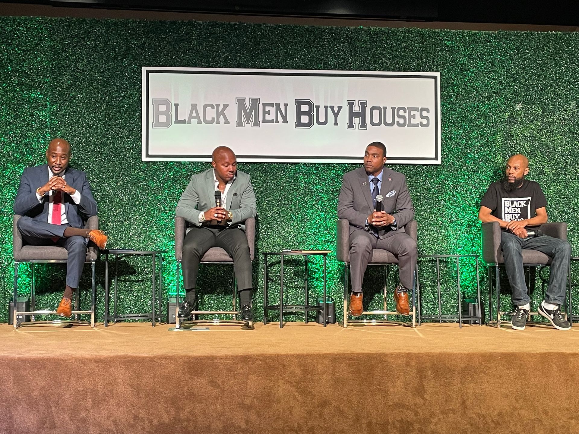 A group of men sitting on a stage