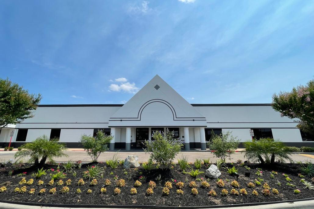 A large white building with a triangle on the front of it