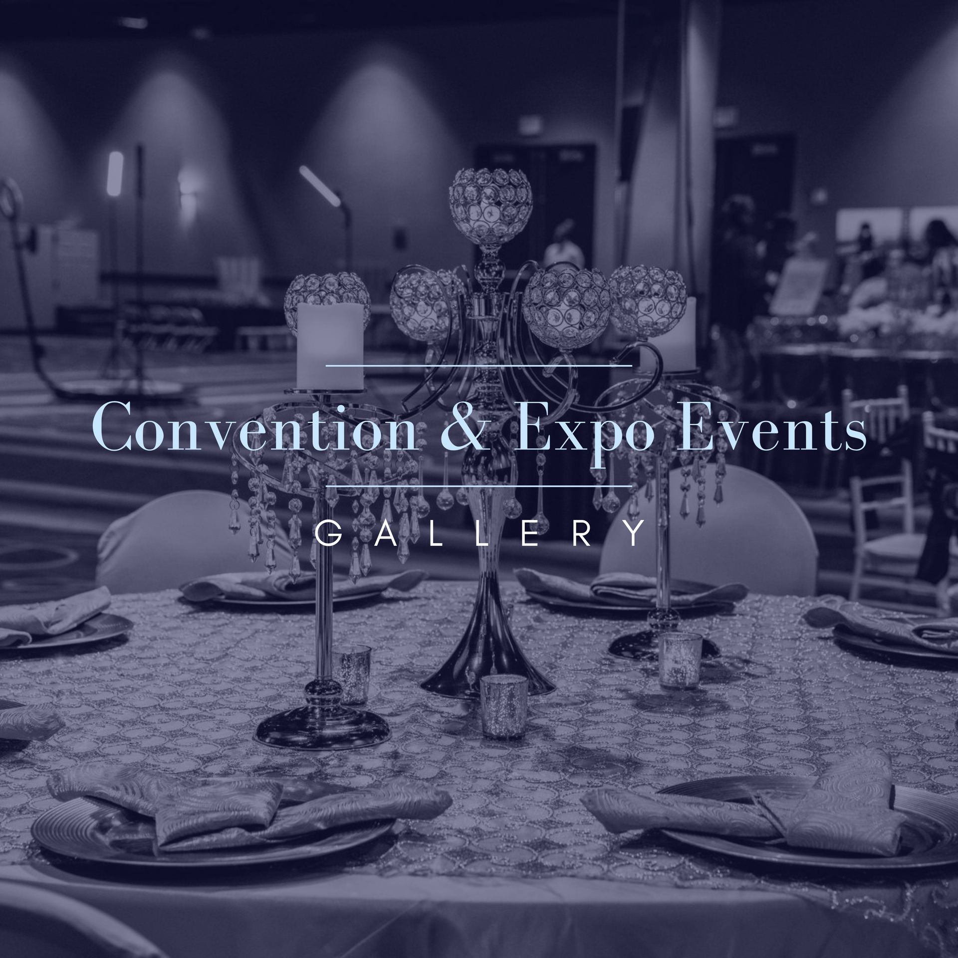 Elegant table setting with centerpiece, in convention hall setting.