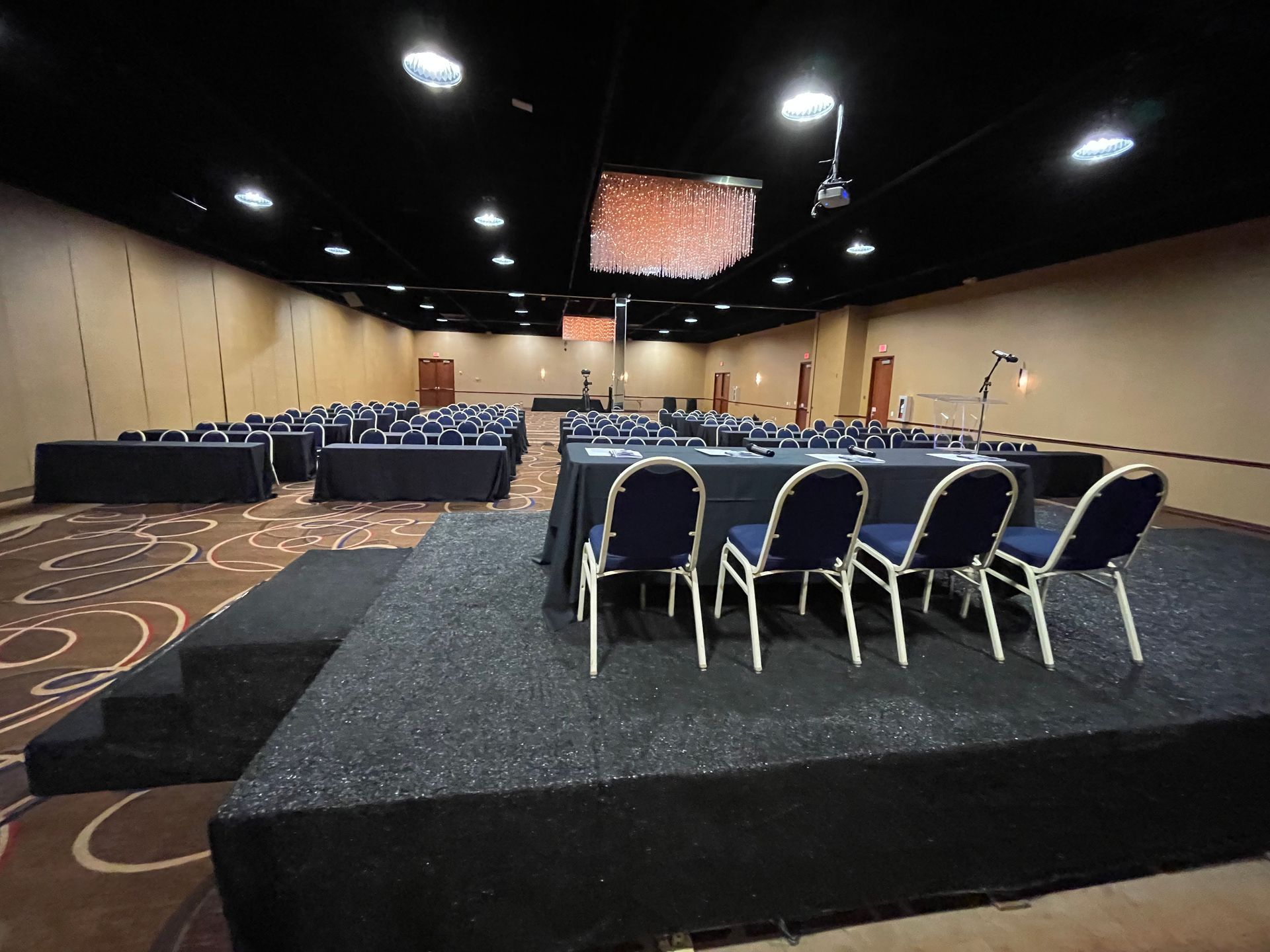 A large conference room with tables and chairs in it
