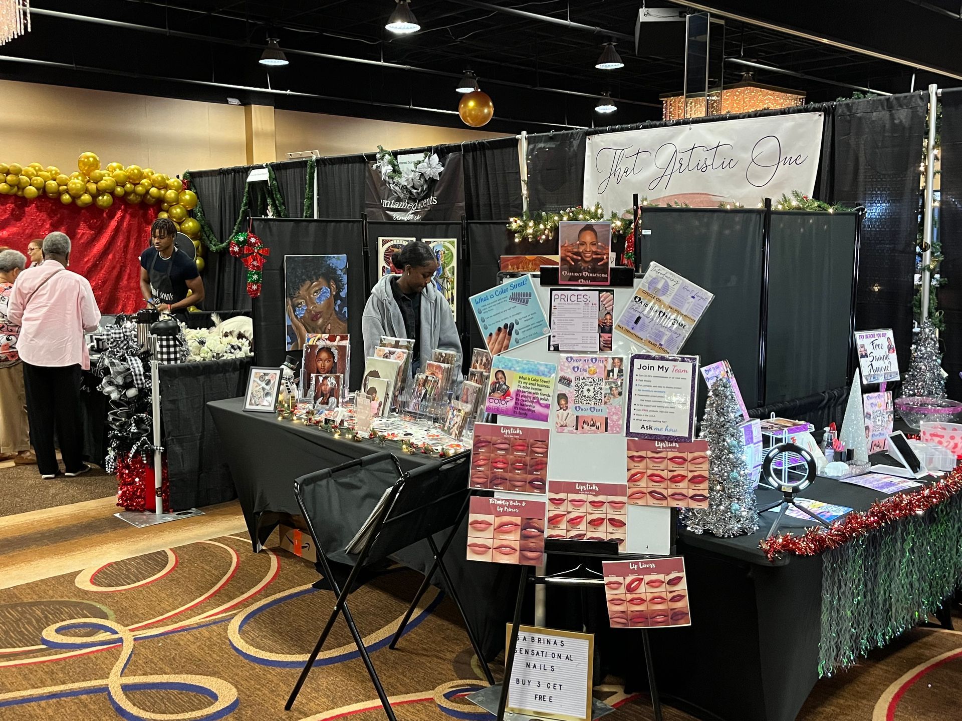 A group of people are standing around a table at a convention.