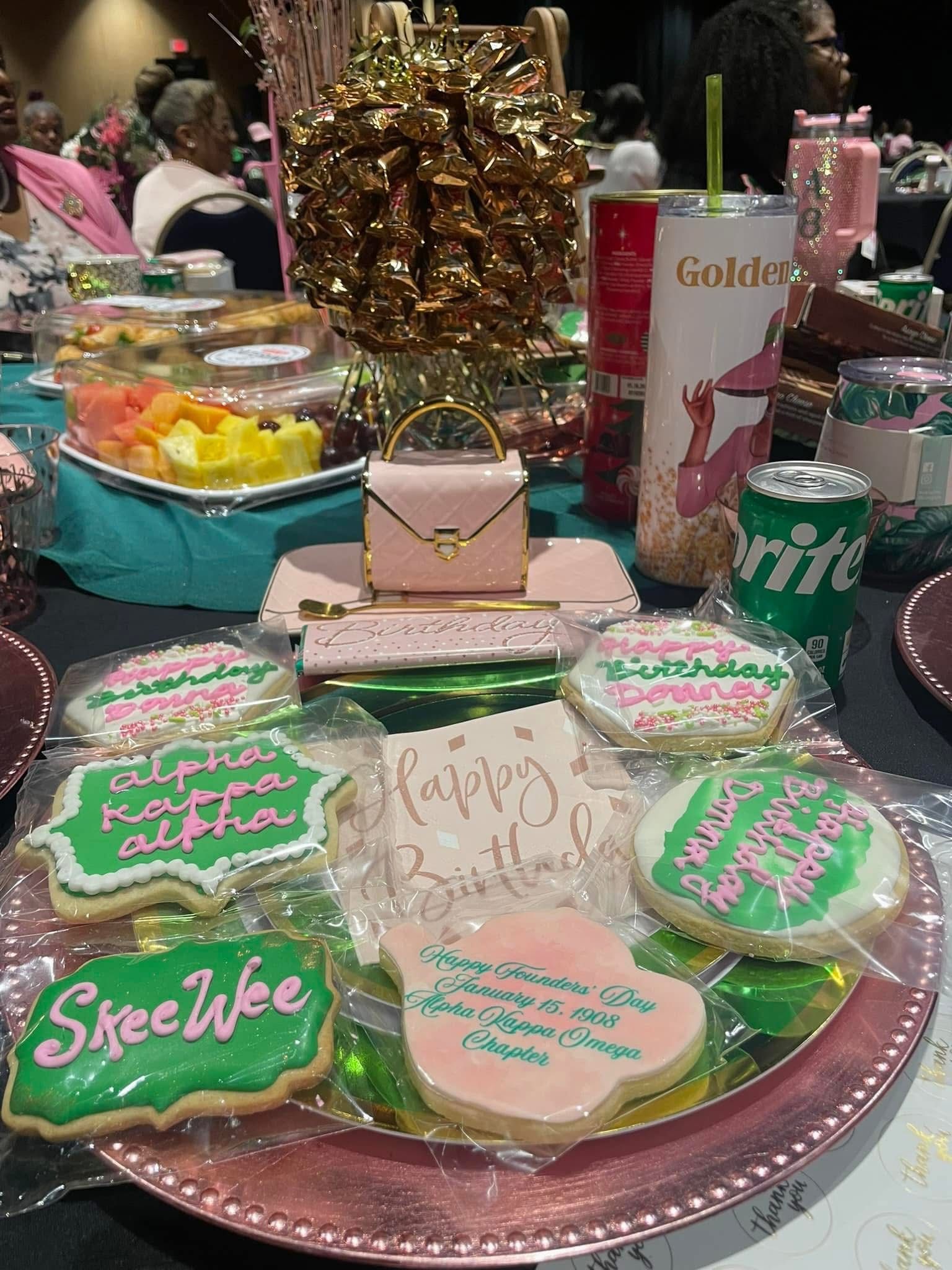 A plate of cookies with a purse on top of it on a table.