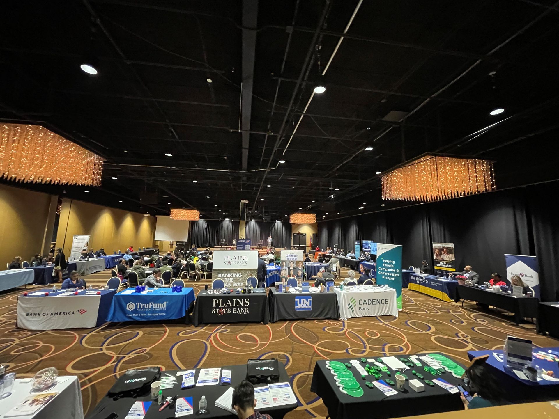 A large room filled with tables and chairs at a job fair.