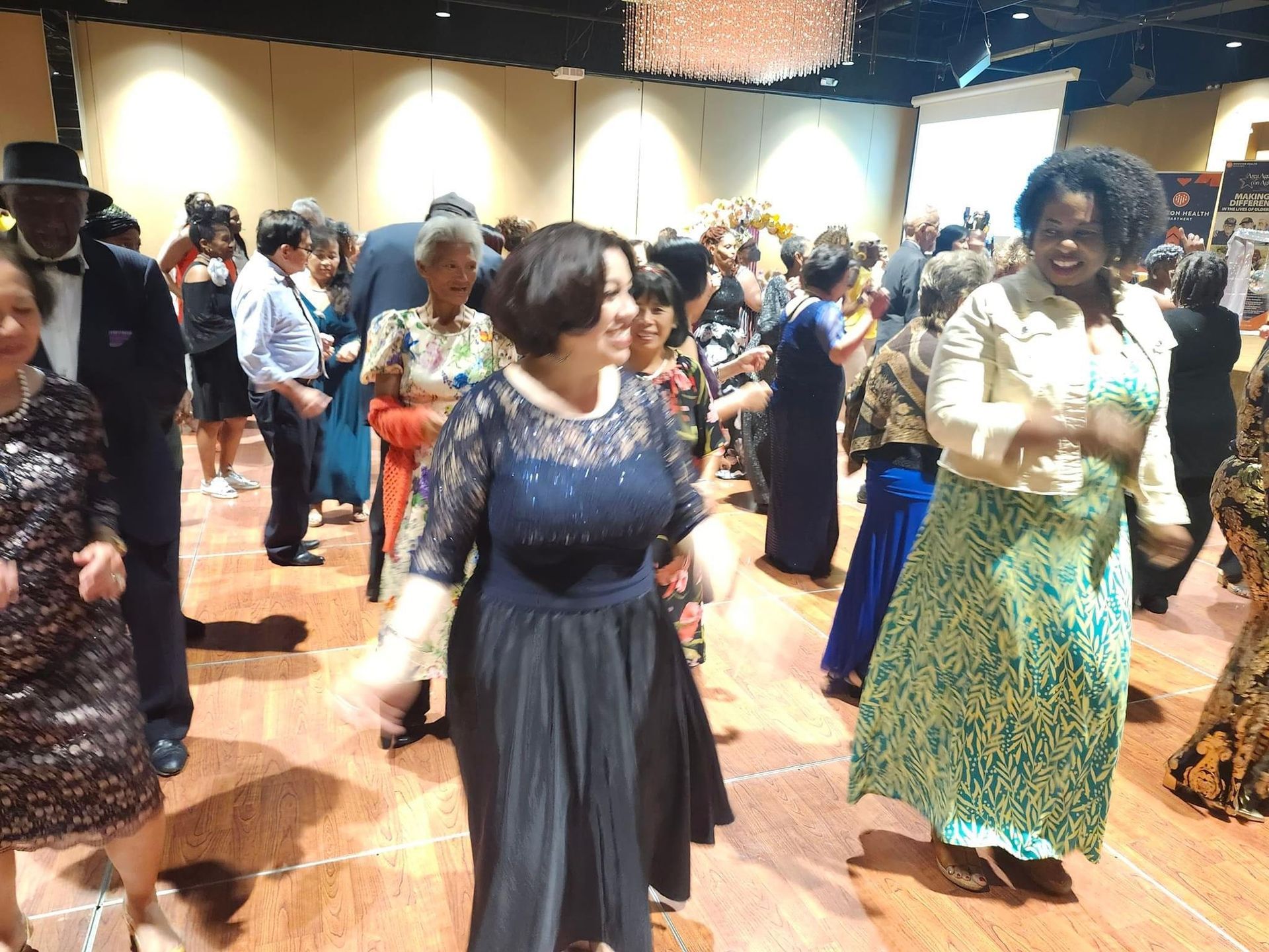 A group of people are dancing on a dance floor.