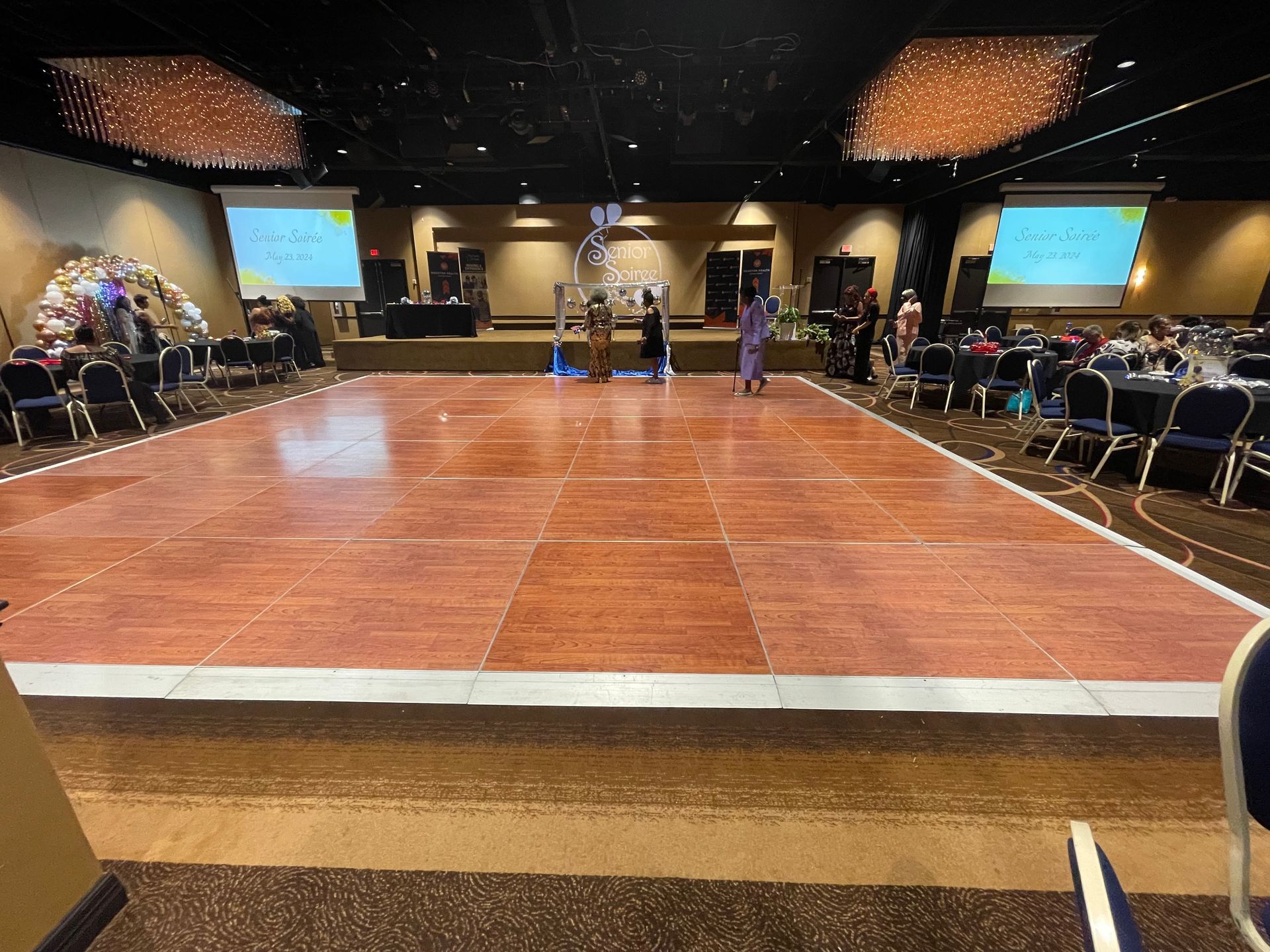 There is a large dance floor in the middle of the room.