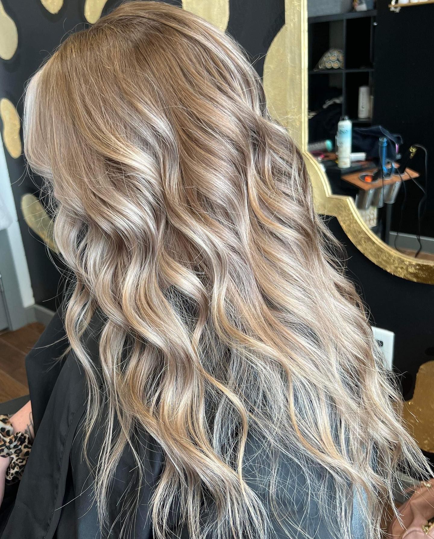Woman's wavy, highlighted brown hair.