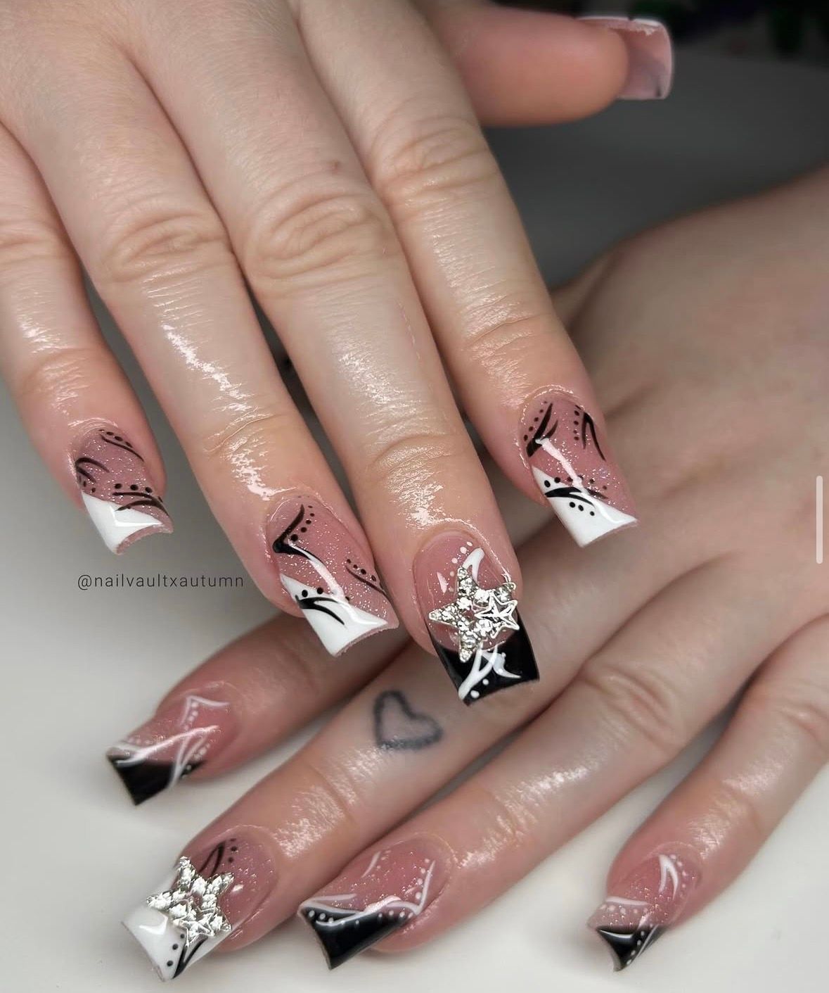 Hands with square-shaped nails; black, white, and clear design with jewel accents.