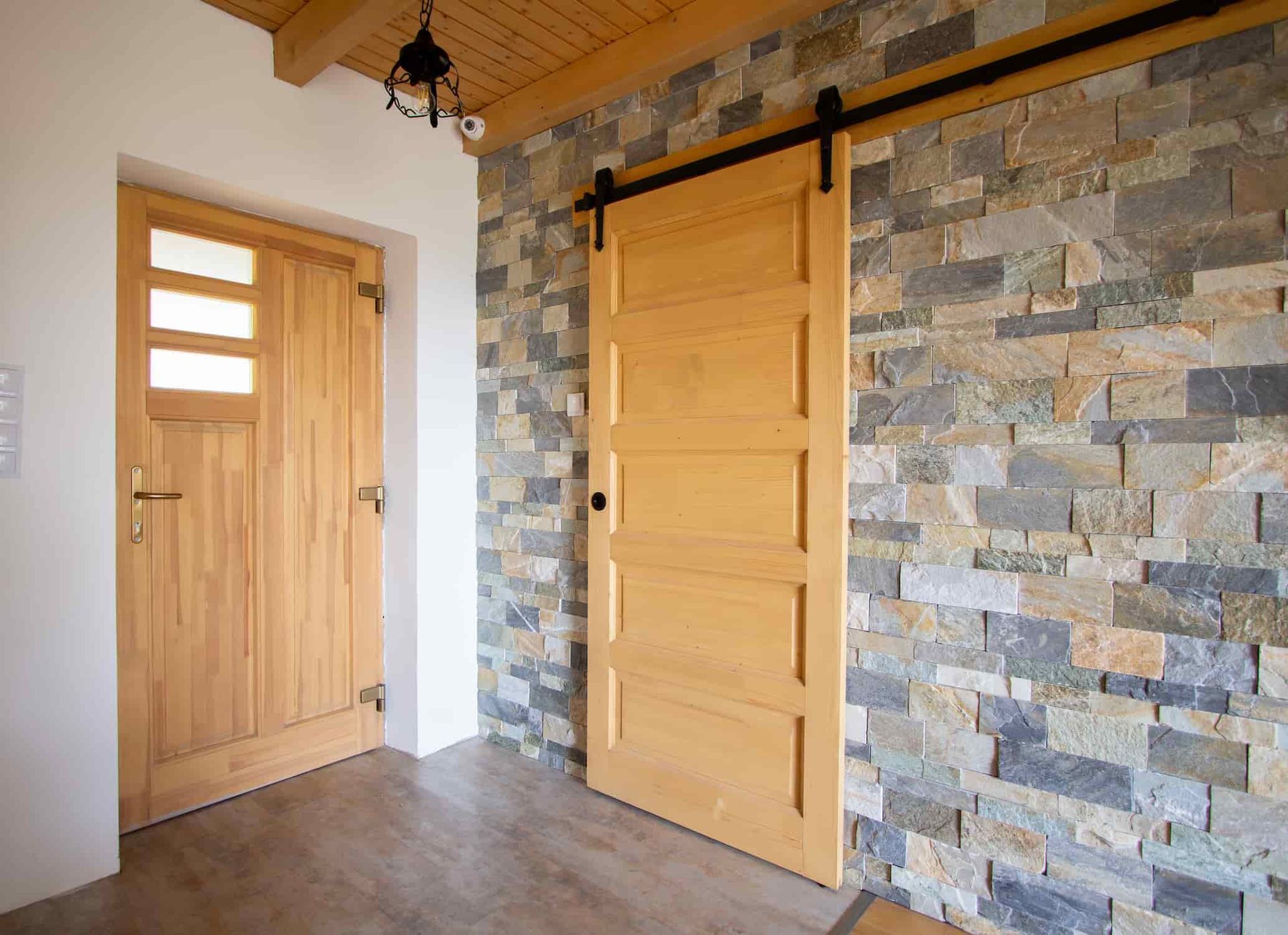 A Hallway With a Wooden Door and a Stone Wall — Dynamic 2-Pack In Rockville, QLD