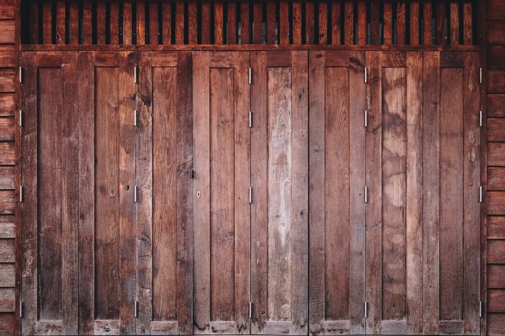 A Close Up of a Wooden Door With Shutters on a Wooden Wall — Dynamic 2-Pack In Rockville, QLD