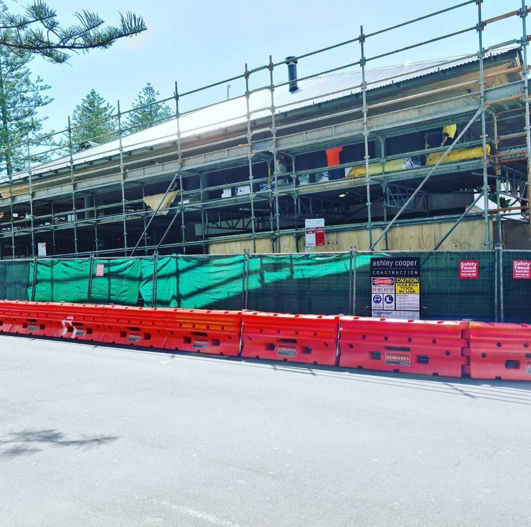 Building Under Construction With Scaffolding and a Red Barrier — Safety Fence Australia in Middle Pocket, NSW