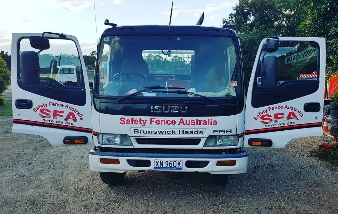 White Truck With the Doors Open is Parked on a Gravel Road — Safety Fence Australia in Middle Pocket, NSW