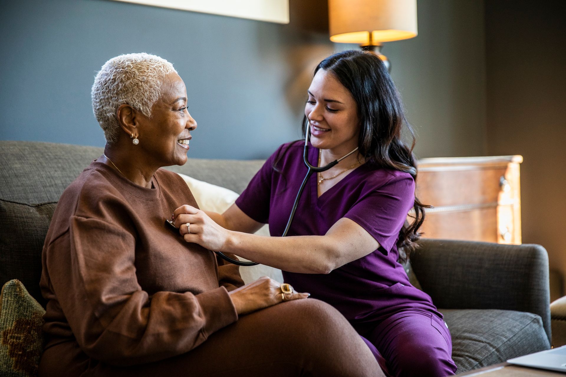 Nurse checking senior woman's vital signs in her home, showcasing home health care services. Nurse checking senior woman's vital signs in her home, showcasing home health care services.