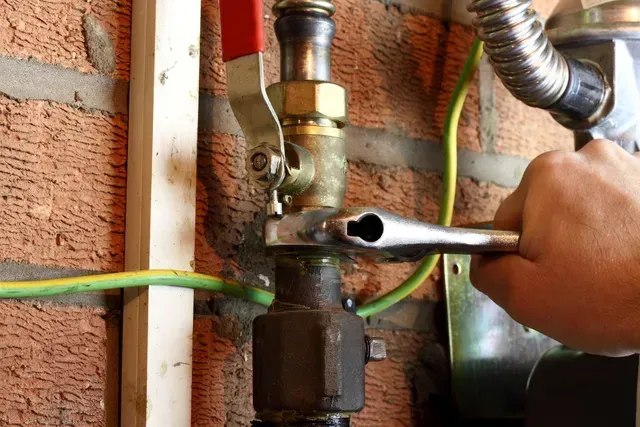 Gas leak repair using crescent wrench.