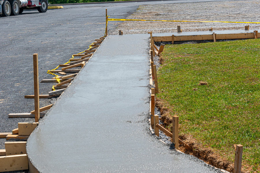 concrete sidewalk being freshly poured