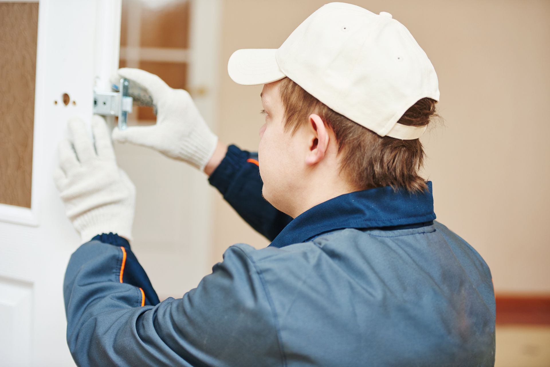 Locksmith installing door lock