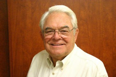 Smiling elderly man in glasses.