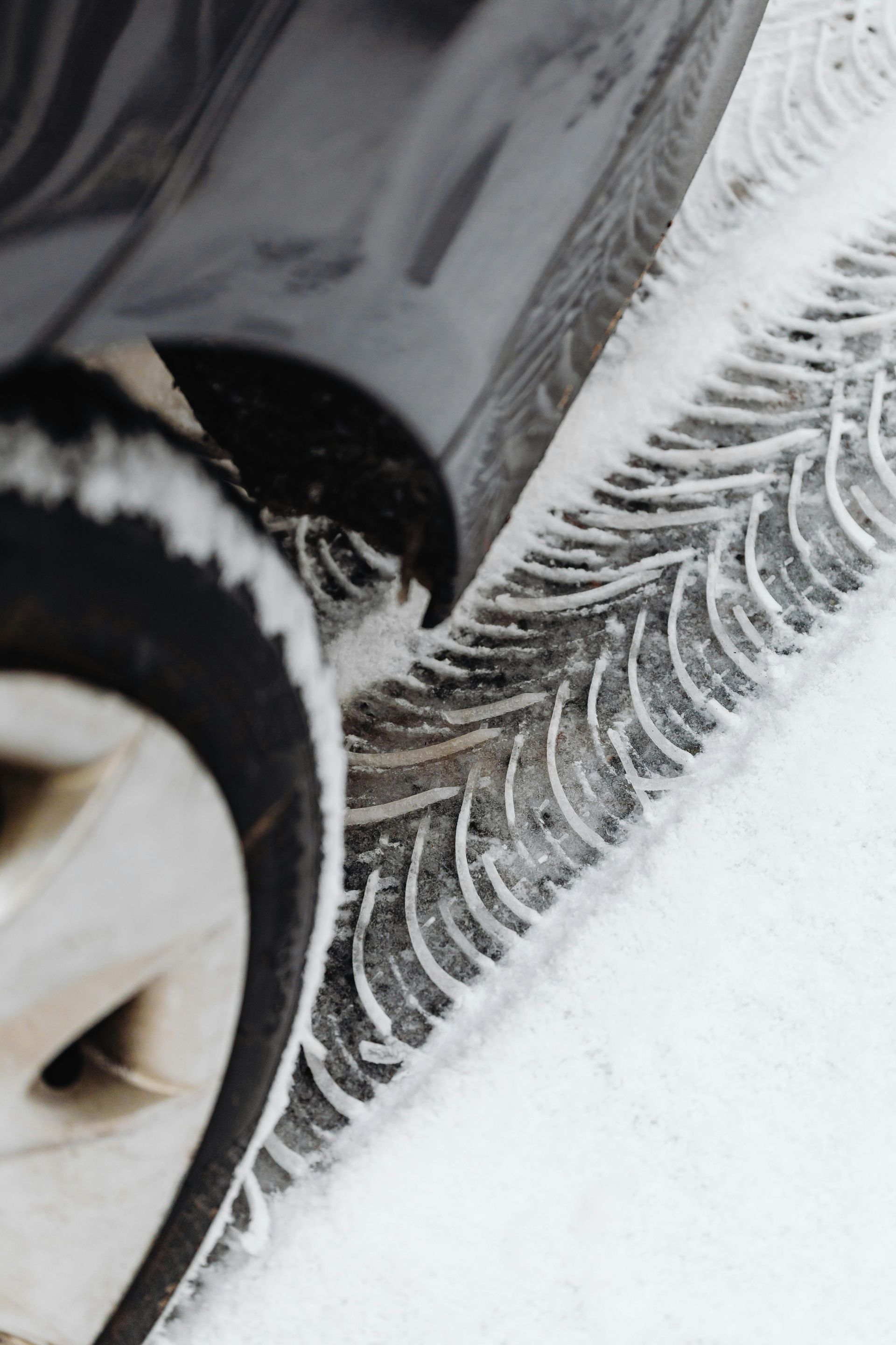 A close up of a car tyre in the snow