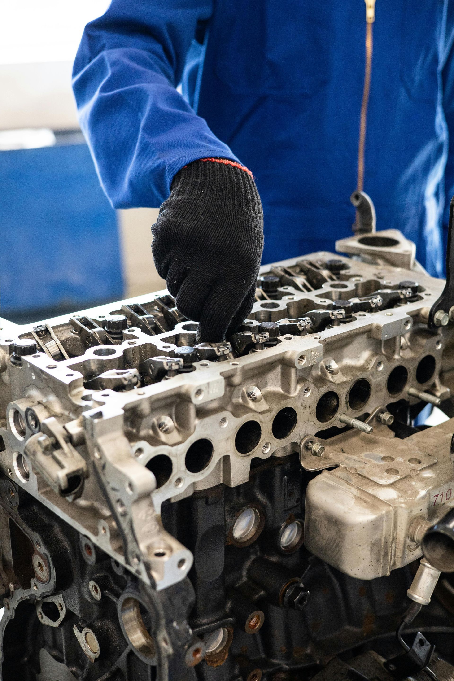 Exposed engine top being serviced by a mechanic