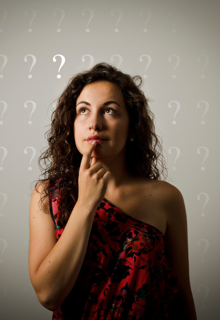 Get more answers at our FAQ page. Woman in red dress thinking with hand on chin against a background of question marks