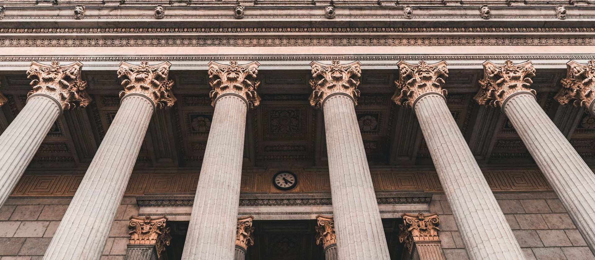 Tall stone columns with ornate capitals at a classical building entrance