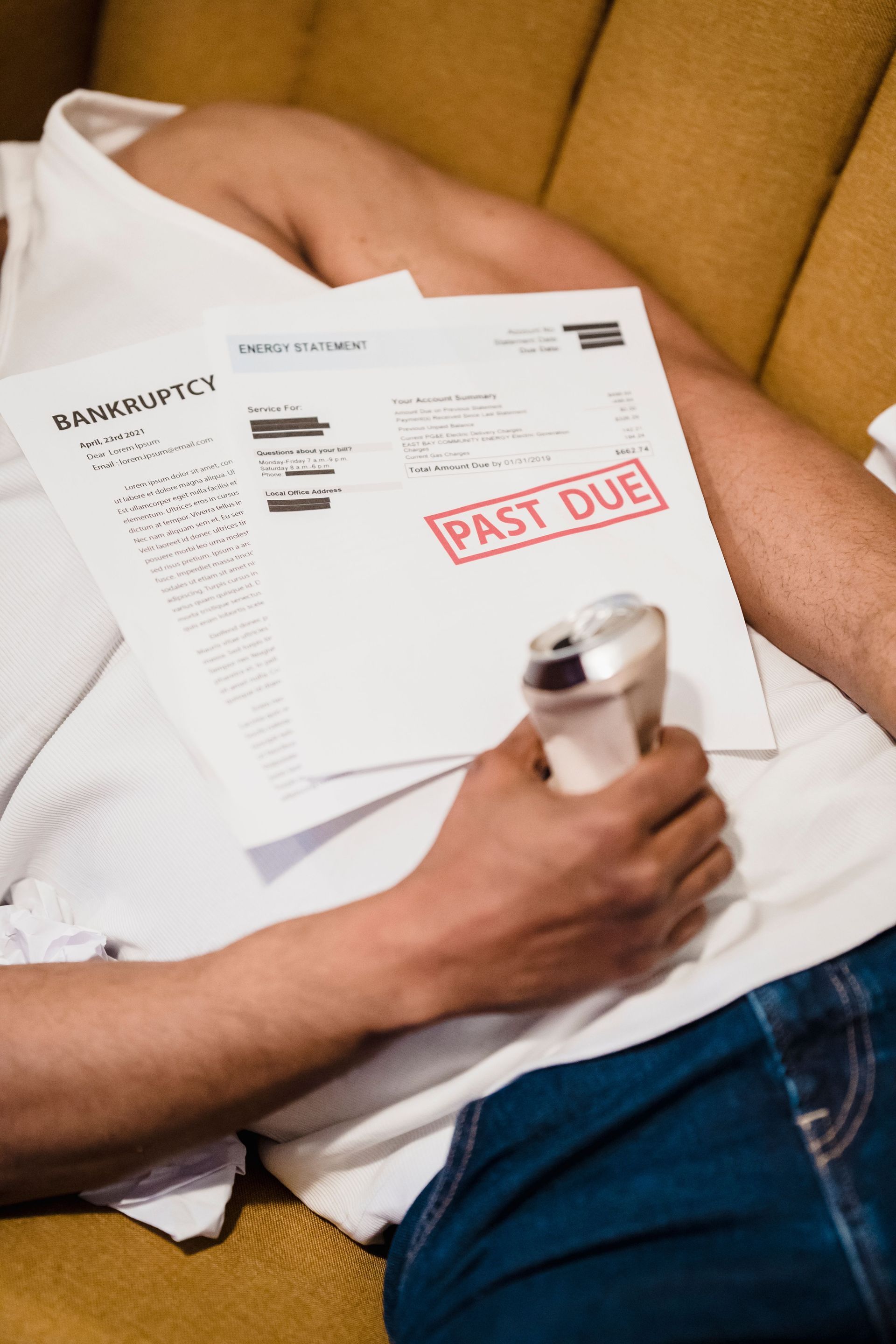 Person holding overdue bills stamped