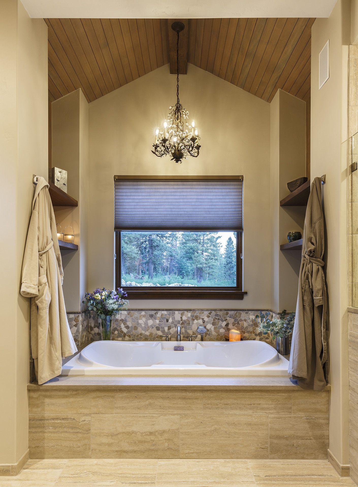 A bathroom with a large tub and a window.