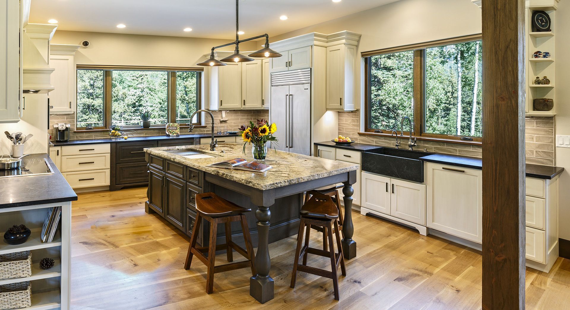 A large kitchen with a large island in the middle of it.