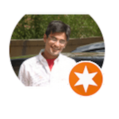 a man in a white shirt is smiling in a circle with an orange star .