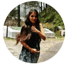 a woman with long hair is standing in a circle .