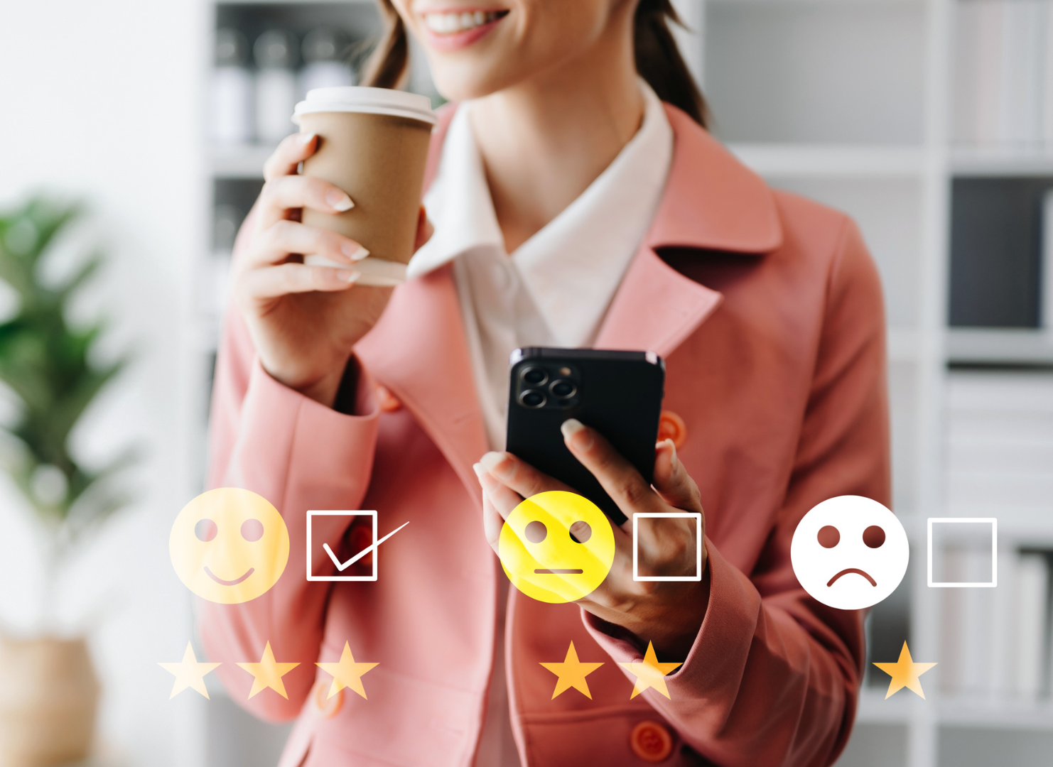 A woman is holding a cup of coffee and using a cell phone.