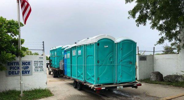 Teal Portable Toilets in the Truck — Miami, FL — A.E.S. Portable Sanitation, Inc.