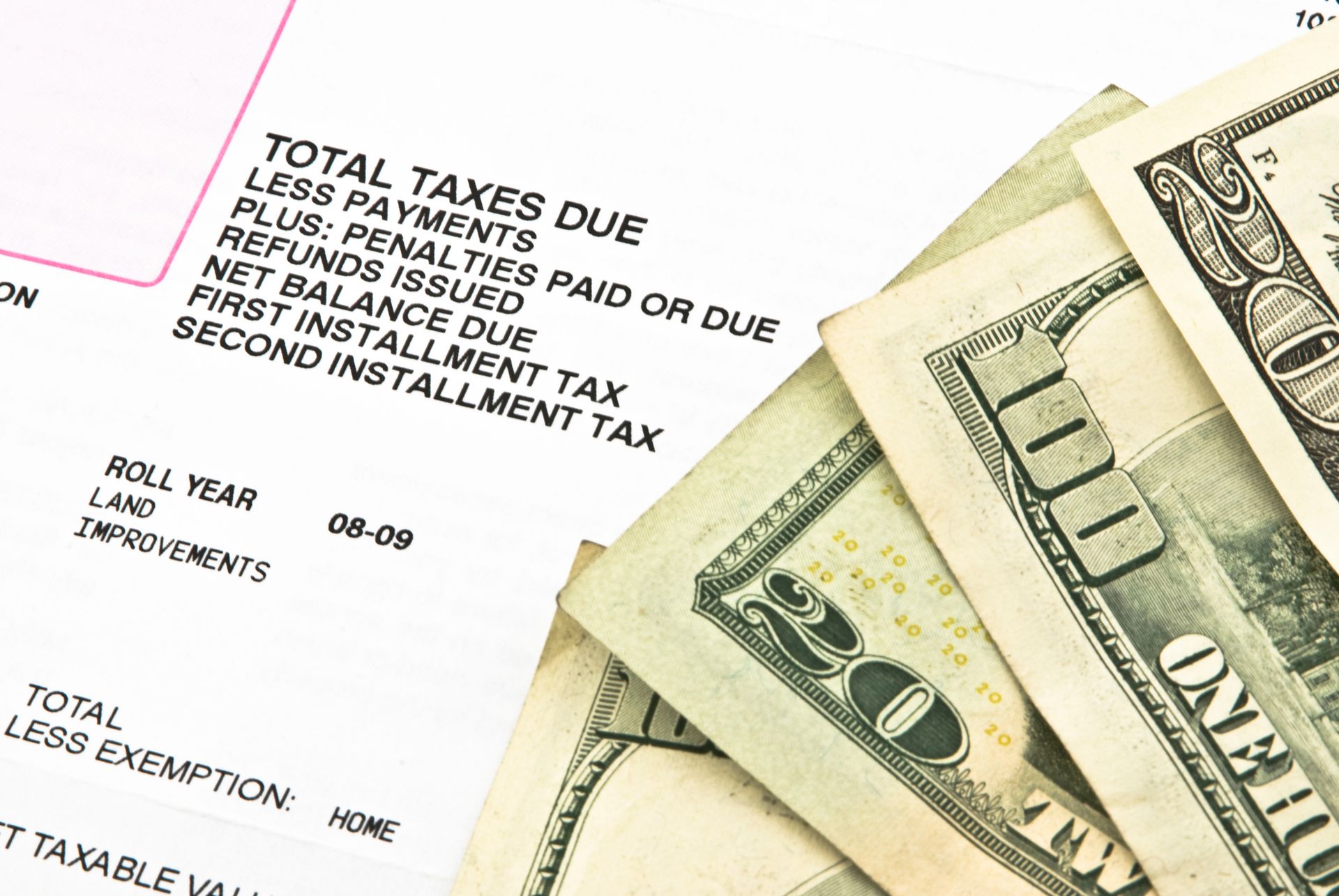money stacked on top of property taxes paperwork