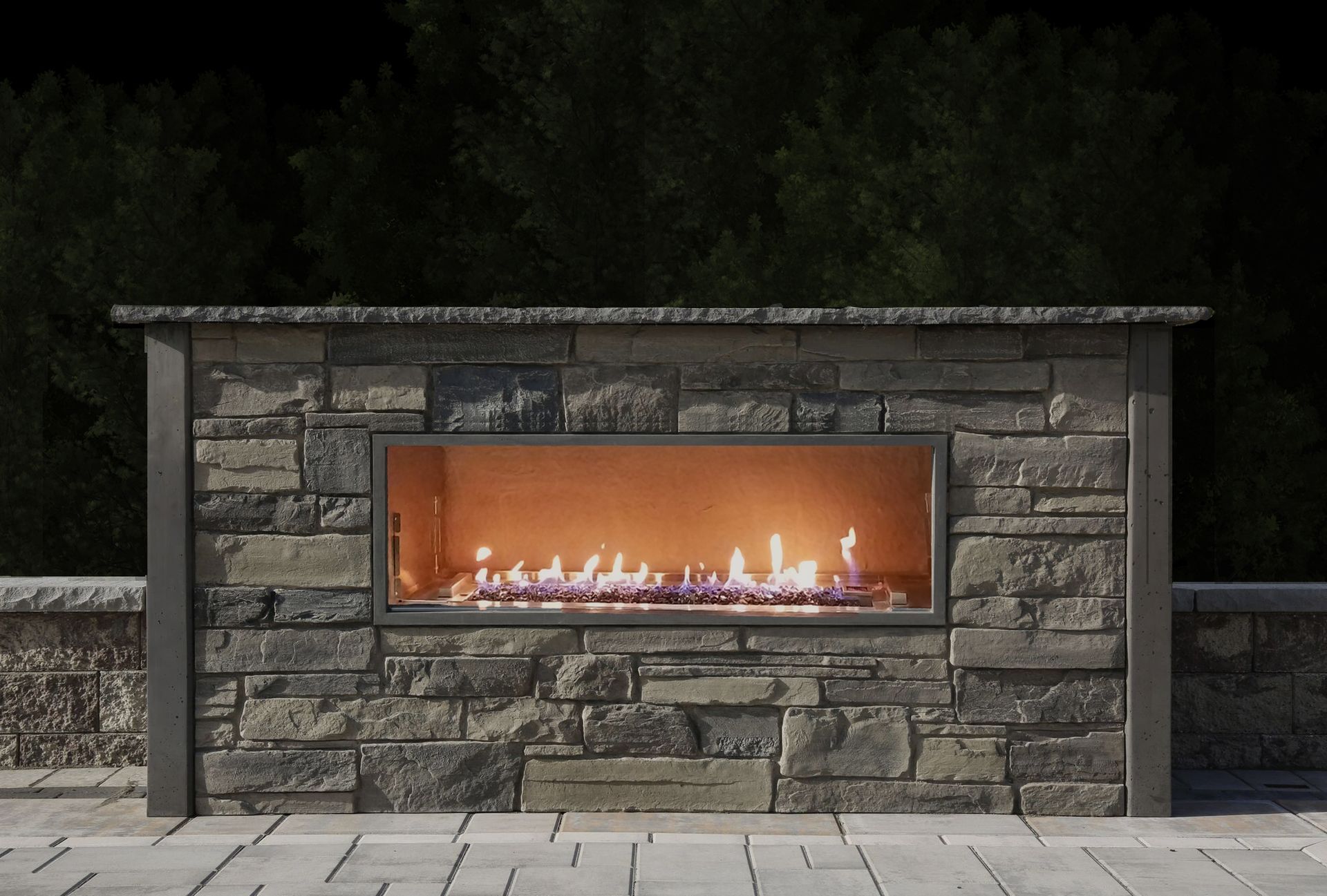 A fireplace is built into a stone wall.