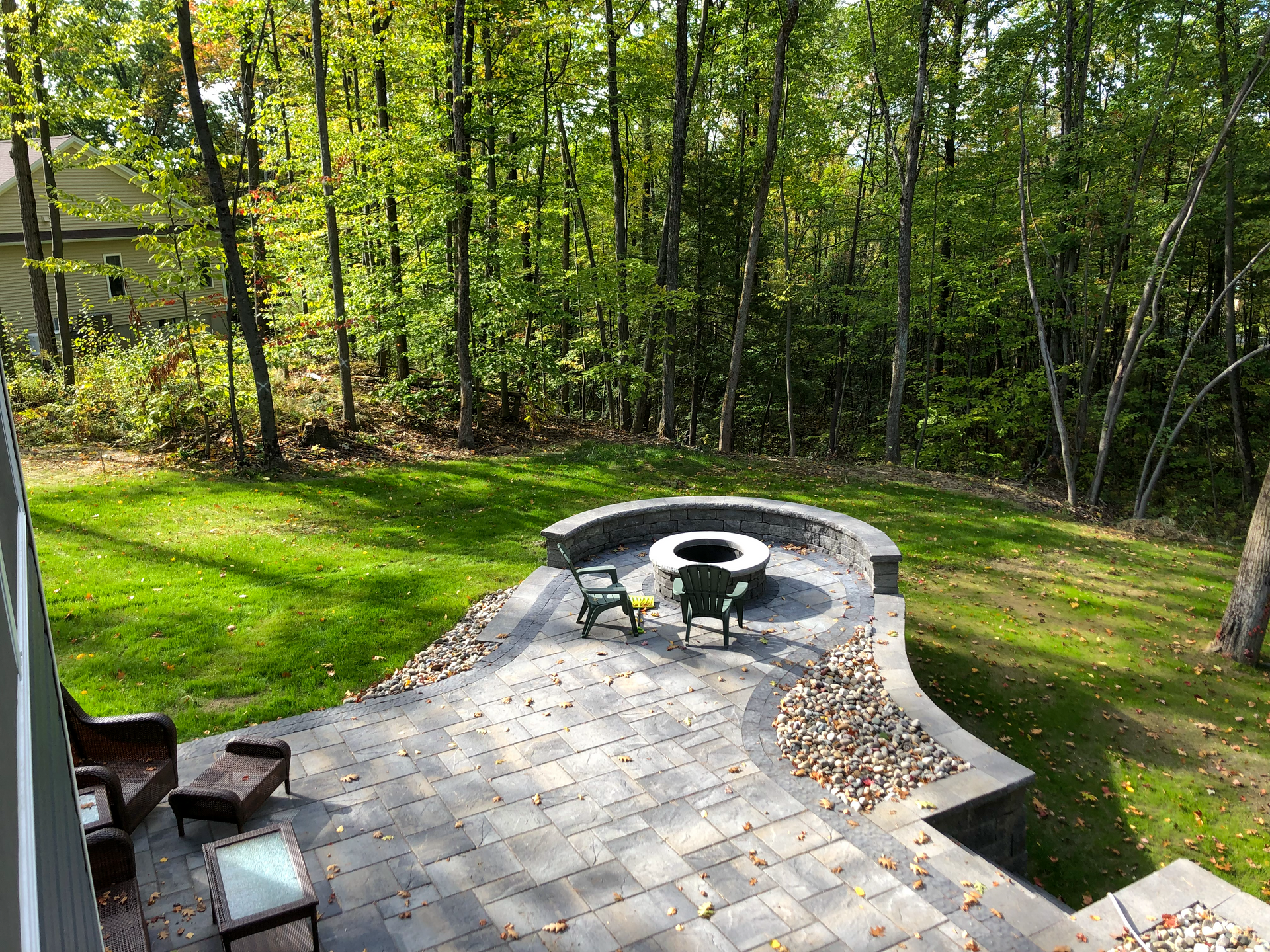 There is a fire pit in the middle of the backyard.
