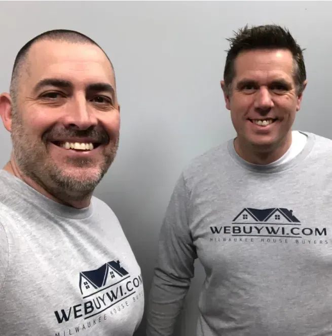 Two men wearing shirts that say webuywi.com