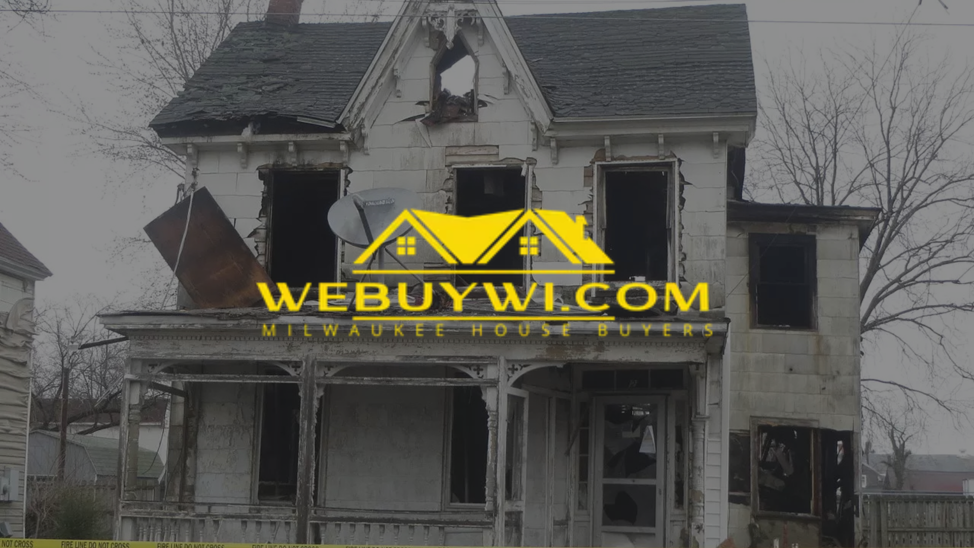 Dilapidated house with fire damage; yellow logo,