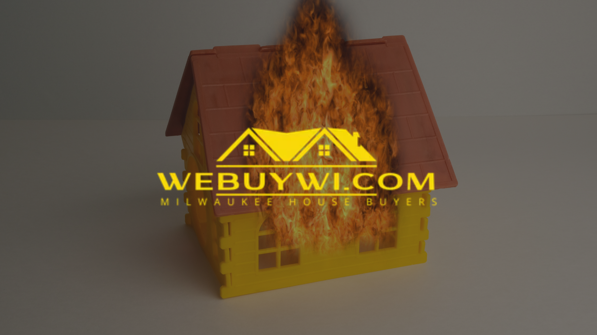 Yellow toy house on fire with 