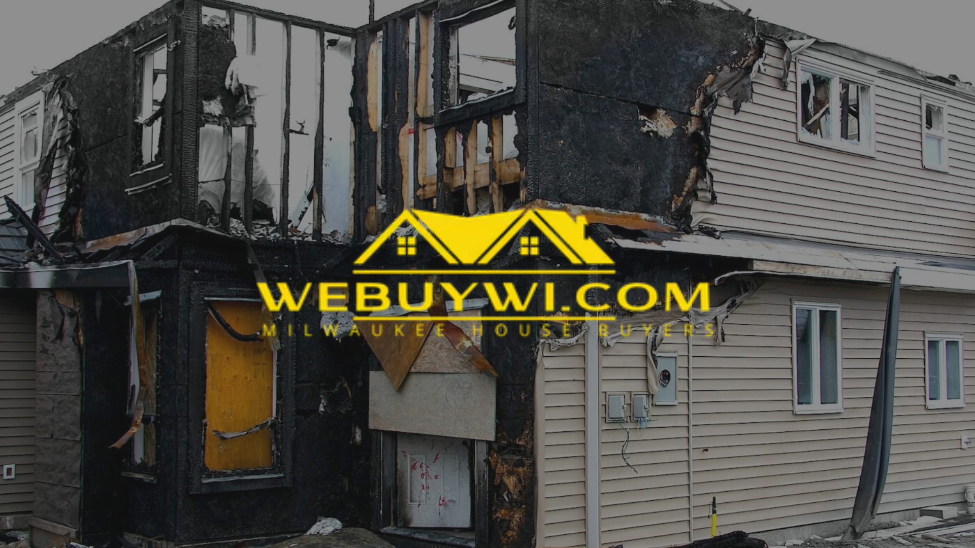 Fire-damaged house with visible charred areas and the